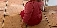 Celeyne participe au concours pour gagner de l'argent avec cette photo : baby, casual, child, cozy, curious, door_frame, floor, hair, head, home, indoor, looking_back, pacifier, person, red_clothing, sitting, tile_floor, toddler, wall, young_child