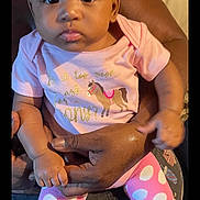 Khaliya joined the competition — help win amazing prizes! baby, child, infant, pink_clothing, polka_dot, headband, bow, sitting, person, adult_hand, couch, indoor, cute, portrait, looking_at_camera, calm, skin, clothing, pattern, holding