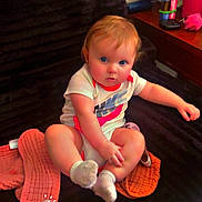 Liliana is registered to the contest to win money with this photo: baby, child, infant, sitting, portrait, blue_eyes, blond_hair, smiling, indoor, chair, blanket, socks, shirt, orange_blanket, furniture, home, fan, water_bottle, colorful, date_stamp