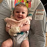 Liliana is registered to the contest to win money with this photo: baby, baby_seat, baby_toys, child, colorful, cute, floor_tiles, happy, indoor, infant, legs, mittens, monkey_design, pink_clothing, portrait, rainbow_design, seat_cushion, smiling, socks, sun_design