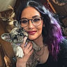 black_clothing, closeup, cozy, deer_head, dog, face, french_bulldog, glasses, hand, indoor, necklace, nose_ring, pet, portrait, puppy, purple_hair, rustic, smile, woman, wood_wall