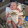 Blake joined the competition — help win amazing prizes! baby, infant, onesie, dinosaur, cushion, fox_pattern, playpen, sock, toy, plush_toy, blanket, living_room, carpet, furniture, child, person, cute, indoor, resting, comfort