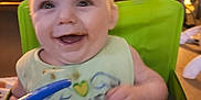 Emmett is registered to the contest to win money with this photo: adult, architecture, baby, babylaughing, beverage, bib, bodypart, breakfast, building, chair, clothing, coffee, coffeecup, couch, cream, cup, cushion, cutlery, dessert, diningtable