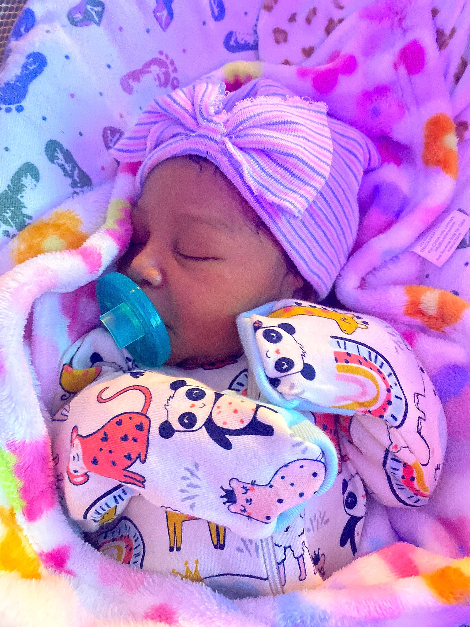 Blessyn joined the competition — help win amazing prizes! baby, baby_products, baby_sleeping, baby_toddler_clothing, bib, cheek, child, comfort, face, happy, headwear, knit_cap, linens, magenta, pattern, person, photograph, pink, purple, textile