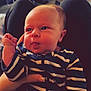 Walker is registered to the contest to win money with this photo: baby, infant, striped_clothing, onesie, face, tongue_out, hand, lap, indoor, couch, person, child, cute, expression, furniture, home, legs, nail_art, soft_lighting, portrait