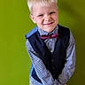 Sebastian joined the competition — help win amazing prizes! child, boy, portrait, smiling, bow_tie, vest, checked_shirt, formalwear, blond_hair, young_person, standing, indoors, green_background, studio_portrait, fashion, clothing, face, happy, looking_at_camera, photography