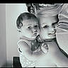 Hermione is registered to the contest to win money with this photo: baby, toddler, child, siblings, portrait, black_and_white, smiling, cuddling, hugging, indoors, family, blonde_hair, curly_hair, dress, stars, close_up, faces, sitting, affection, photograph