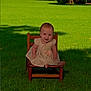 baby, child, dress, chair, grass, outdoor, smile, wooden_chair, sunlight, shadow, happy, sitting, nature, greenery, cute, portrait, young_child, infant, daylight, innocence