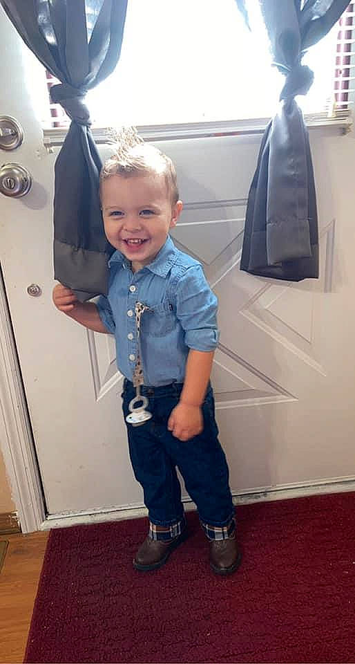 James is registered to the contest to win money with this photo: beauty, child, electric_blue, fashion, flooring, footwear, formal_wear, fun, happy, joint, joy, luggage_and_bags, person, product, shoulder, sleeve, smile, sneakers, standing, t_shirt