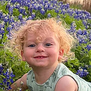 Harrison joined the competition — help win amazing prizes! child, toddler, curly_hair, smiling, bluebonnets, flowers, nature, outdoor, grass, greenery, pond, trees, sunset, happy, cute, baby, plants, spring, crawling, portrait