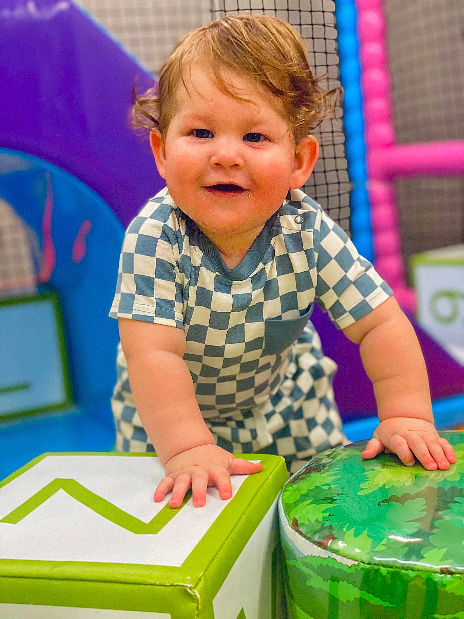 Keion is registered to the contest to win money with this photo: baby, baby_playing_with_toys, baby_toddler_clothing, child, fun, grass, green, happy, joy, leisure, pattern, person, plastic, play, playground, product, recreation, room, sitting, smile