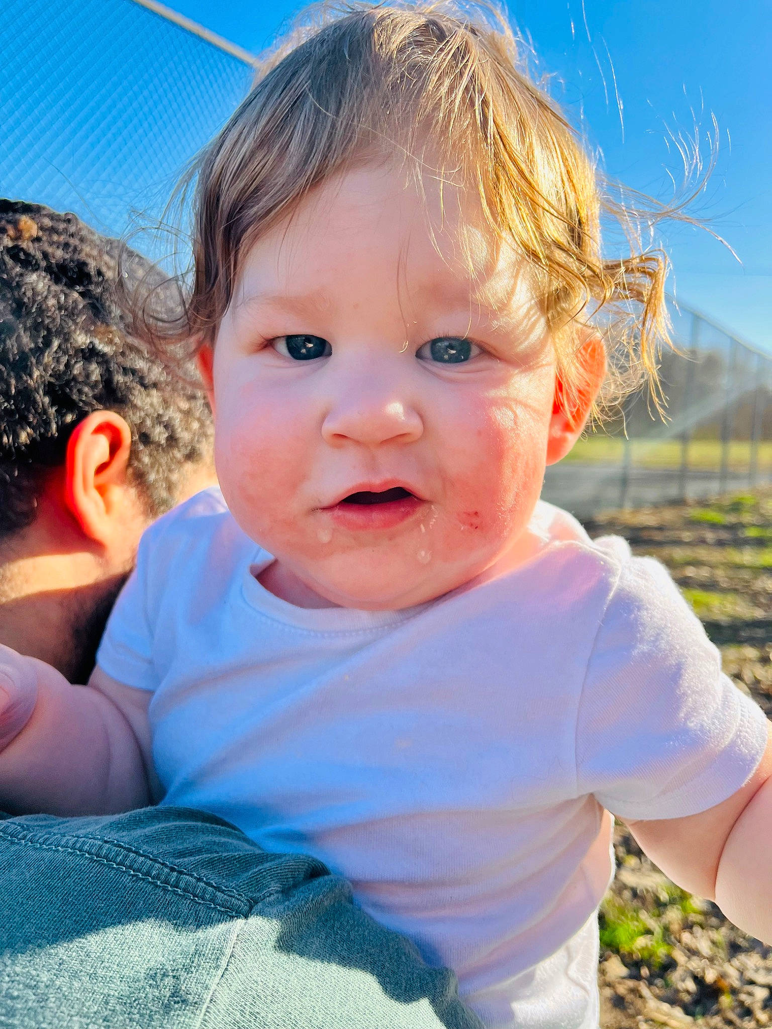 Keion is registered to the contest to win money with this photo: azure, baby, chin, eye, facial_expression, fun, grass, happy, head, iris, leisure, mouth, nose, people_in_nature, person, plant, skin, sky, sunlight, toddler