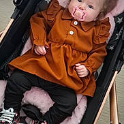 Julyanna a rejoint le concours — aidez-le/la à gagner de superbes lots ! baby, black_pants, child, clothing, comfort, cushion, cute, dress, face, floor, footwear, indoor, infant, pacifier, person, pink_pillow, seated, sneakers, star_pattern, stroller
