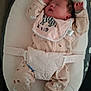 baby, newborn, sleeping, pink_outfit, bib, zebra, baby_lounger, cushion, infant, cute, footwear, socks, minnie_mouse, child, indoors, resting, person, soft, comfortable, sleep