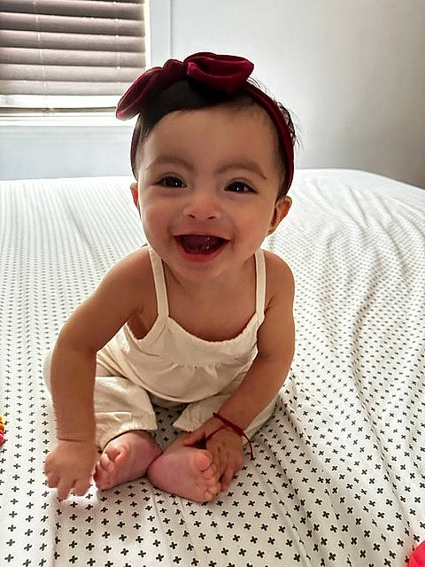 Meadow is registered to the contest to win money with this photo: arm, baby, baby_toddler_clothing, cheek, eye, face, finger, flooring, foot, fun, goggles, happy, head, iris, joy, pattern, person, skin, sleeve, smile
