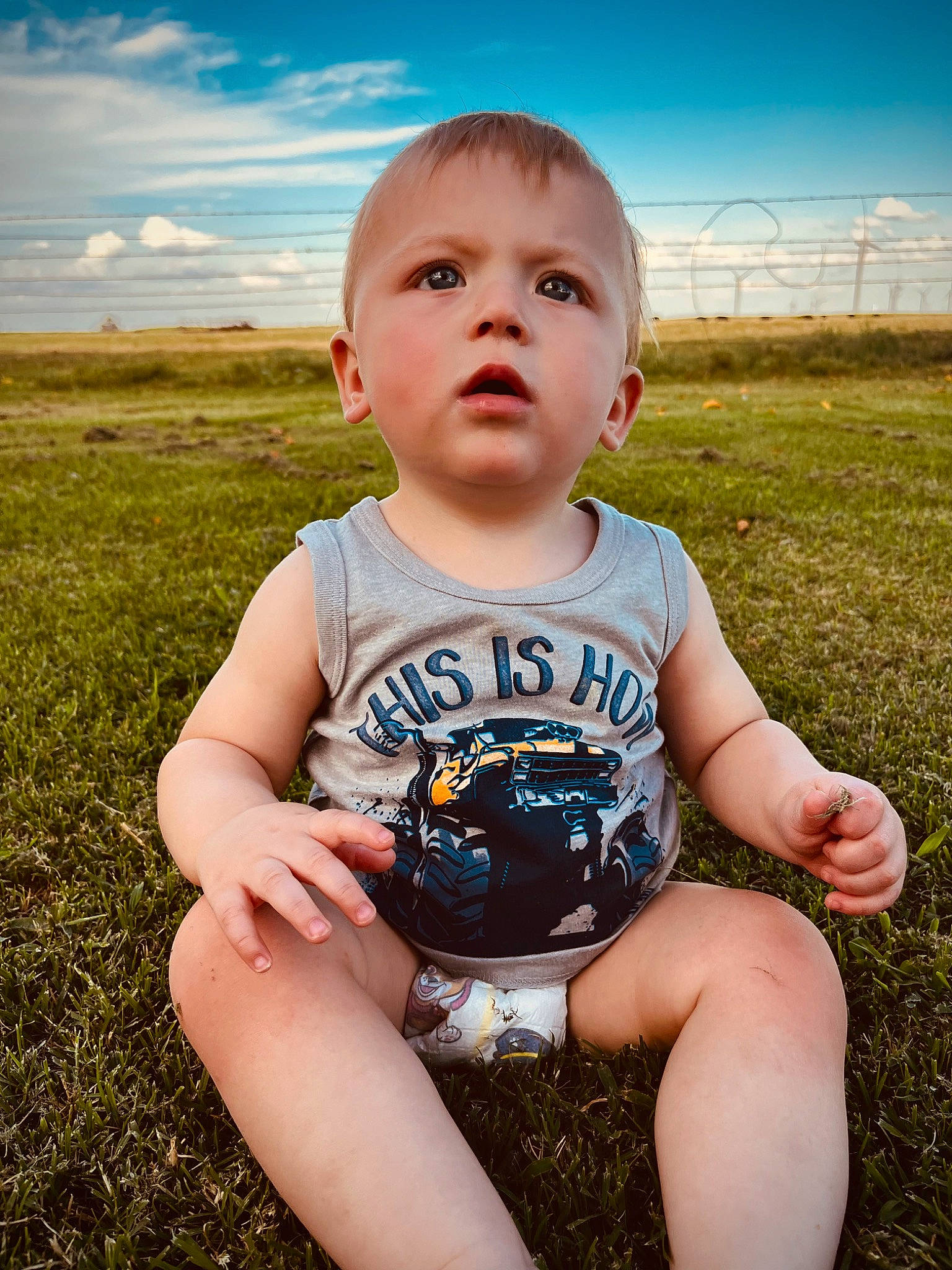 Carsyn is registered to the contest to win money with this photo: azure, baby_toddler_clothing, cloud, finger, flash_photography, fun, grass, grass_family, grassland, happy, iris, meadow, people, people_in_nature, person, plant, skin, sky, standing, sunlight
