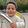 Tyler a rejoint le concours — aidez-le/la à gagner de superbes lots ! toddler, child, smiling, playground, metal_bar, outdoor, park, yellow_slide, happy, person, curly_hair, grip, daylight, casual_clothing, young, nature, fun, play, recreation, joy