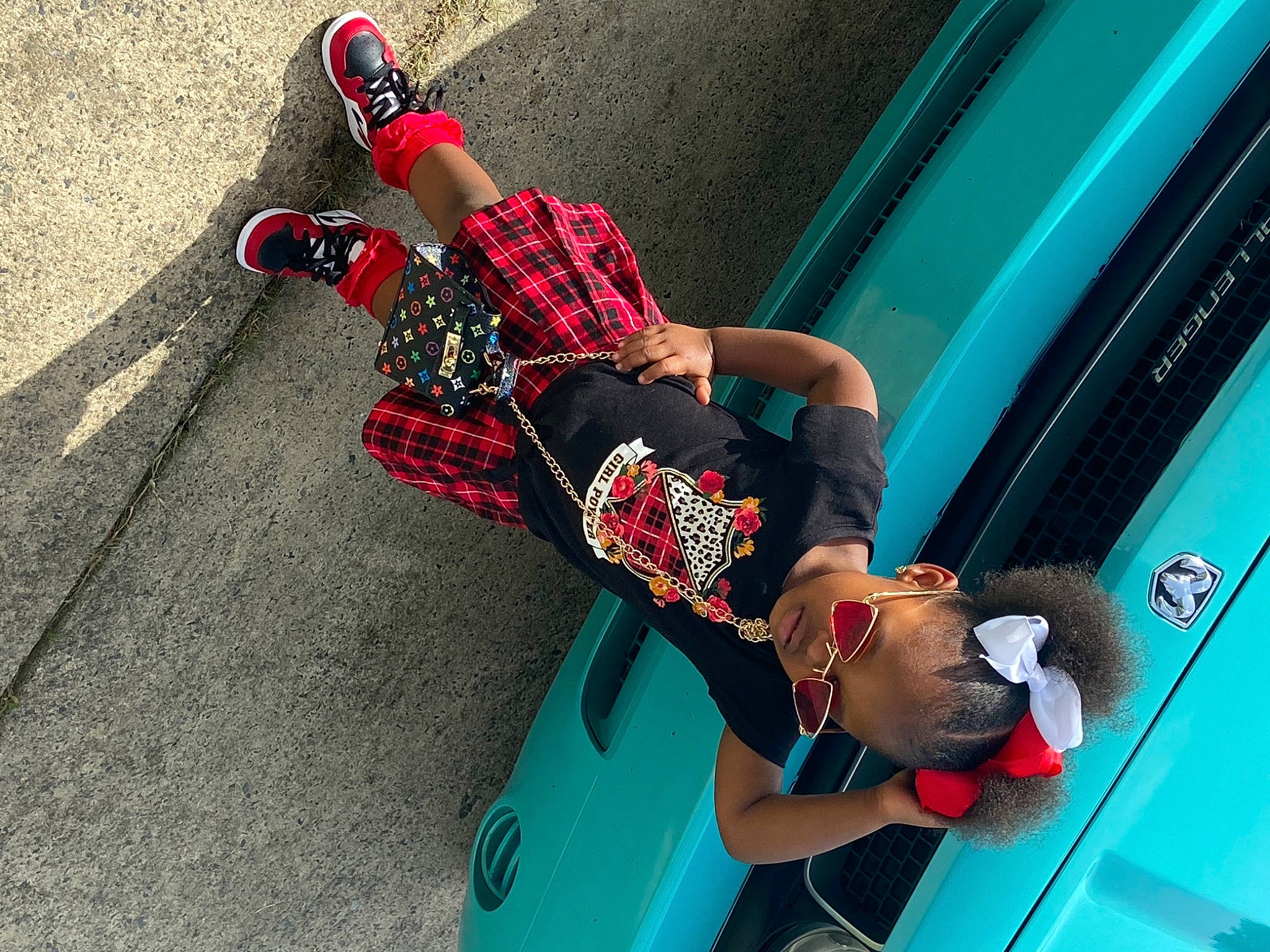 Kamani joined the competition — help win amazing prizes! automotive_design, automotive_exterior, automotive_lighting, automotive_tire, blue, bumper, car, hood, knee, leisure, motor_vehicle, person, recreation, red, street_fashion, sunglasses, thigh, tire, trunk, vehicle_door