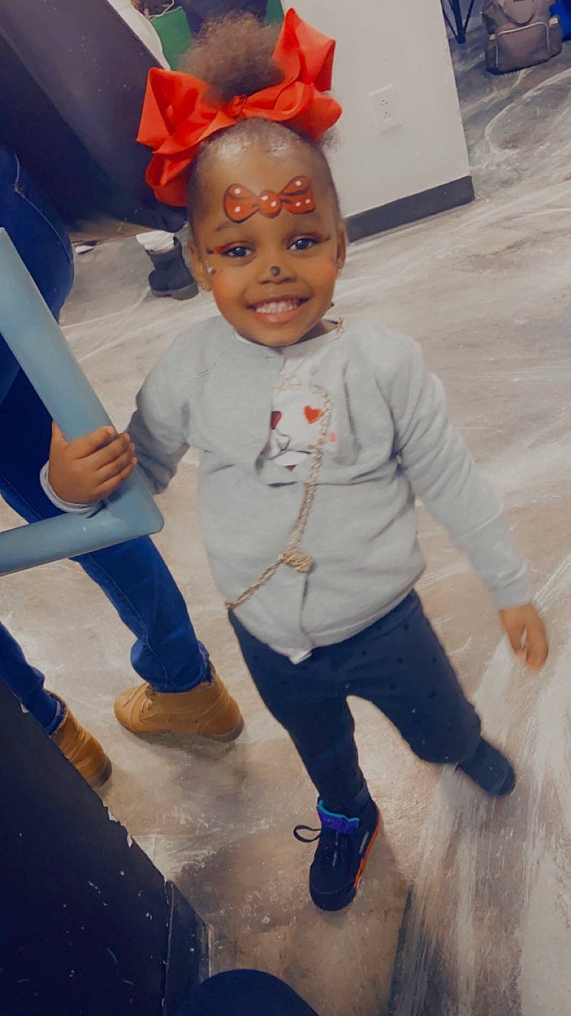 Kamani is registered to the contest to win money with this photo: blue, child, costume, facial_expression, floor, flooring, fun, gesture, happy, head, joy, leg, mouth, nose, person, shoe, skin, sleeve, smile, standing