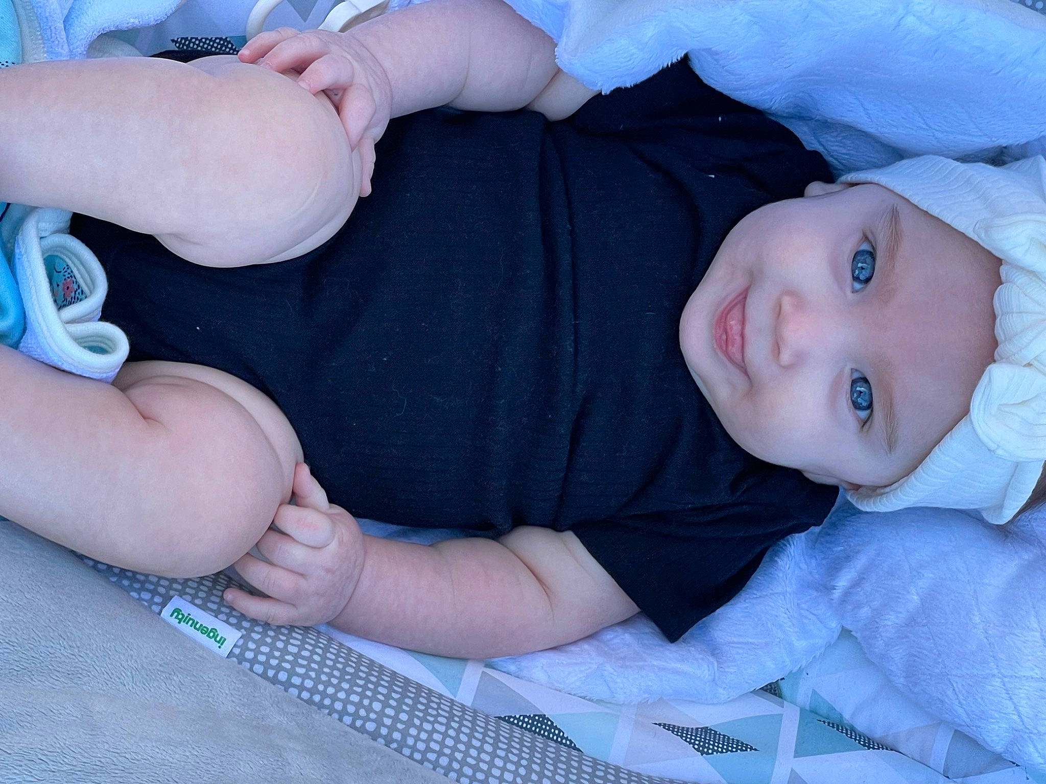 Alice is registered to the contest to win money with this photo: baby, baby_toddler_clothing, cheek, chest, comfort, eye, finger, gesture, hand, headwear, human_body, iris, mammal, mouth, person, skin, sleeve, smile, thumb, toddler