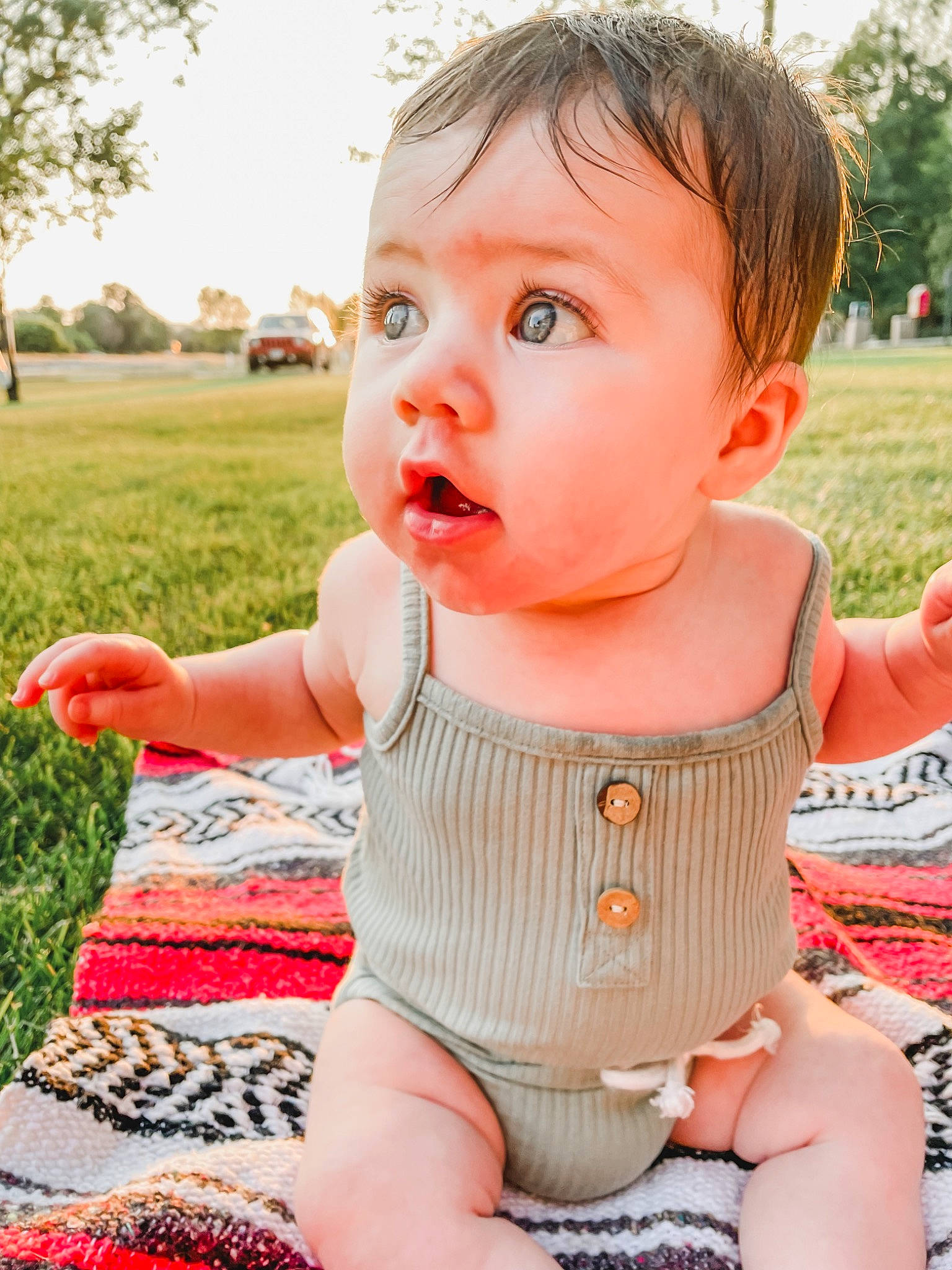Opal is registered to the contest to win money with this photo: baby, baby_toddler_clothing, cheek, child, dress, face, fun, grass, happy, lip, orange, pattern, person, photograph, pink, plant, skin, sleeve, summer, surprise