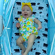 Oaklee Ann joined the competition — help win amazing prizes! baby, child, stroller, yellow_headband, colorful_outfit, bear_pattern, blanket, happy, smiling, infant, clothing, footwear, indoor, person, cute, playful, legs, face, head, seated