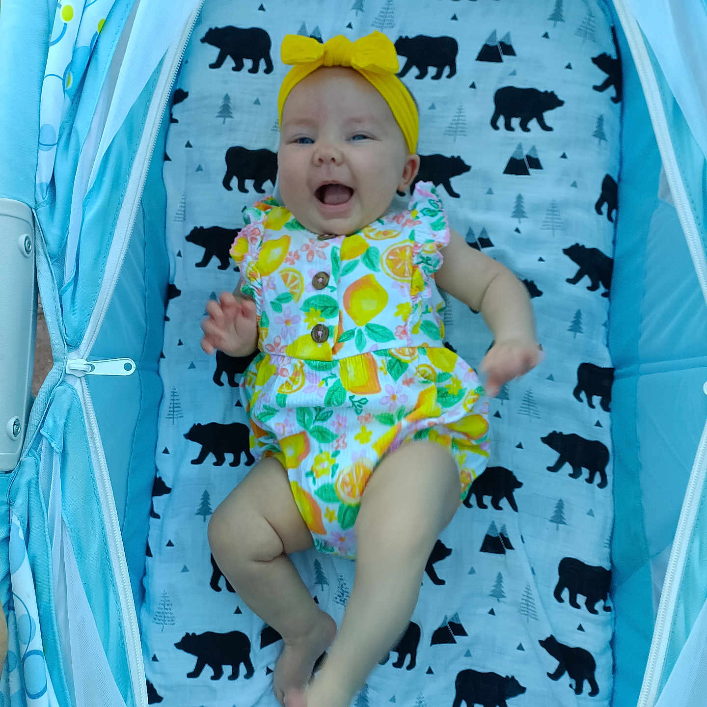 Oaklee Ann joined the competition — help win amazing prizes! baby, bear_pattern, blanket, child, clothing, colorful_outfit, cute, face, footwear, happy, head, indoor, infant, legs, person, playful, seated, smiling, stroller, yellow_headband