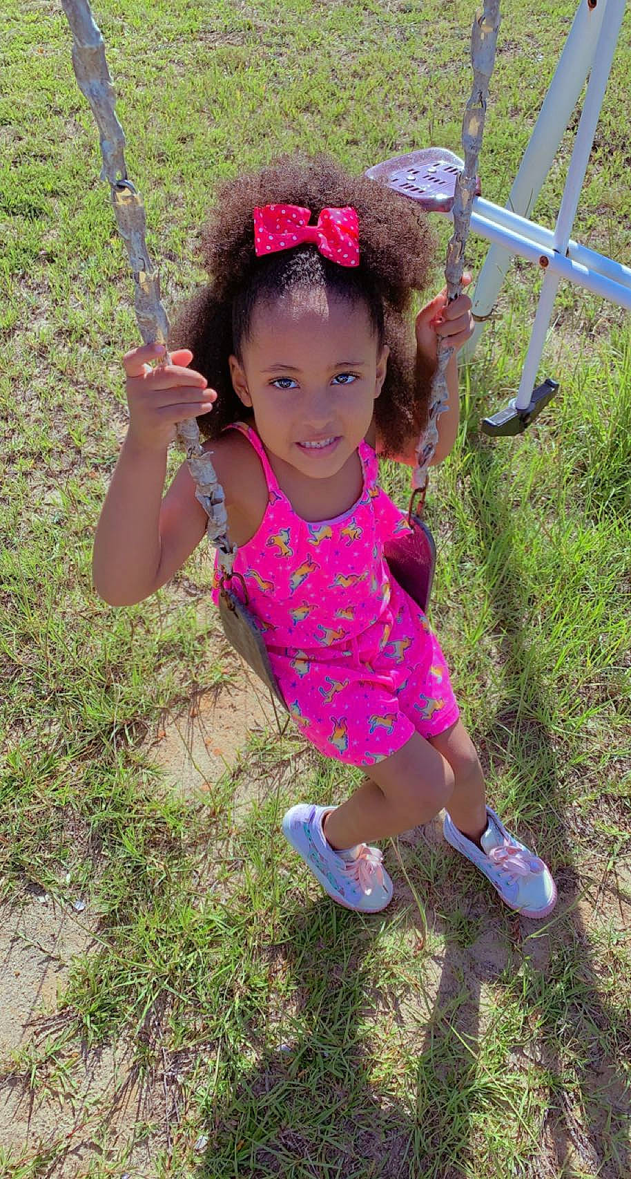 Kaylee joined the competition — help win amazing prizes! baby_toddler_clothing, child, face, fashion_accessory, fence, fun, grass, happy, head, joy, leisure, magenta, people_in_nature, person, pink, plant, recreation, sandal, smile, soil