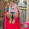Luna is registered to the contest to win money with this photo: child, girl, slide, indoor, kitchen, toy_car, pigtails, tank_top, denim_shorts, carpet, refrigerator, cabinet, playtime, happy, smiling, home, colorful, footwear_free, cute, active