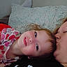 child, adult, kiss, face_paint, heart_shapes, pillow, couch, indoor, close_up, affection, family, portrait, smile, casual_clothing, relaxation, love, cozy, bedroom, person, cute