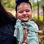 Isla is registered to the contest to win money with this photo: baby, smile, face, headband, knitted_sweater, child, person, outdoor, nature, portrait, holding, happy, cute, young_child, apparel, closeup, warm_clothing, hand, background_blur, daylight