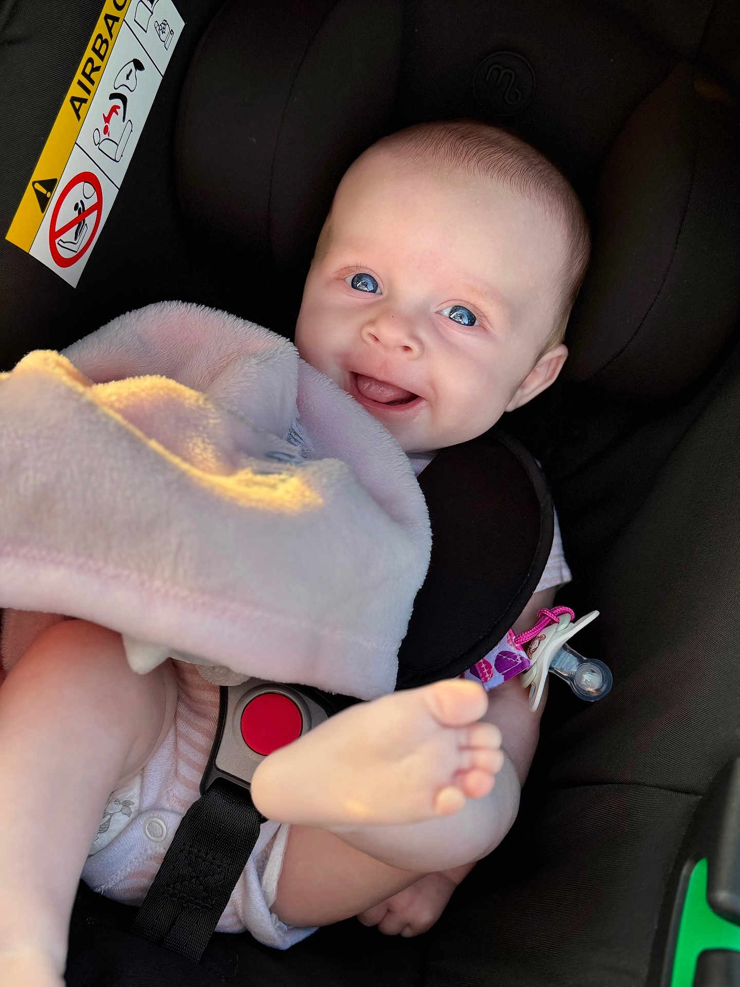 Amiya-Mae is registered to the contest to win money with this photo: baby, infant, car_seat, blanket, smile, foot, blue_eyes, child, safety_belt, pacifier, pink, cute, happy, indoor, closeup, skin, head, seat, clothing, playful