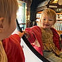 child, toddler, reflection, mirror, red_jacket, indoor, wooden_beams, window, light, smile, face, hand, clothing, person, jeans, floor, wood, casual, cute, cozy