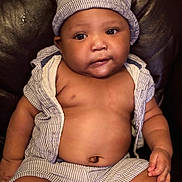 Micah joined the competition — help win amazing prizes! baby, child, infant, hat, striped_clothing, shorts, shirtless, sitting, leather_chair, indoor, cute, chubby_cheeks, portrait, skin, hand, face, eyes, mouth, young, person