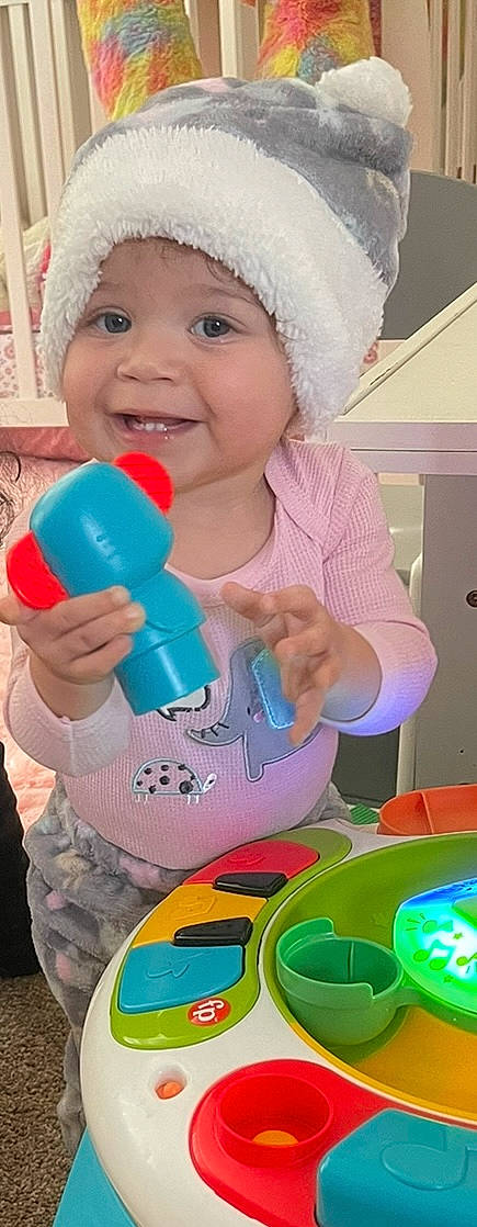 Jaelyn joined the competition — help win amazing prizes! baby, baby_playing_with_toys, baby_products, baby_toddler_clothing, cap, child, drinkware, finger, fun, happy, headwear, joy, magenta, nail, party_supply, person, pink, plastic, plastic_bottle, play
