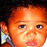 child, close_up, face, eyes, curly_hair, earring, skin, expression, portrait, baby, young_child, pout, lips, person, indoor, headshot, cute, looking_at_camera, bright, eyelashes