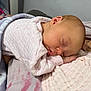 Aurora joined the competition — help win amazing prizes! baby, sleeping, infant, blanket, pink_clothing, person, closeup, peaceful, resting, indoor, soft_texture, newborn, skin, head, hand, blanket_pattern, nap, quiet, comfort, family