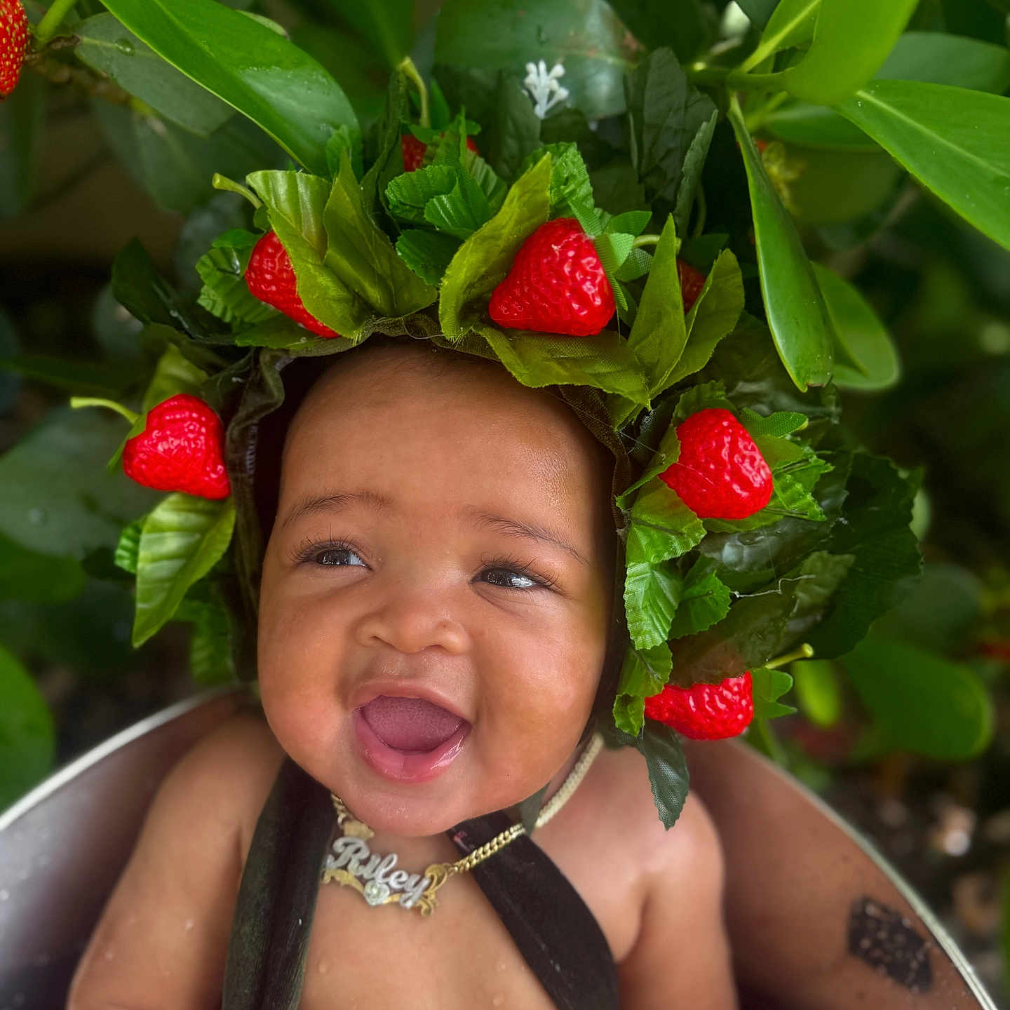 Riley Jordan joined the competition — help win amazing prizes! baby, cheerful, child, closeup, cute, fruit, greenery, happy, headwear, infant, leafy_crown, nature, necklace, outdoor, plant, portrait, skin, smiling, strawberry, water_drops