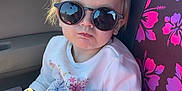Ivy is registered to the contest to win money with this photo: accessories, baby, car, clothing, cream, cushion, dessert, face, food, glasses, head, homedecor, icecream, pants, person, photography, portrait, sitting, sunglasses, t_shirt