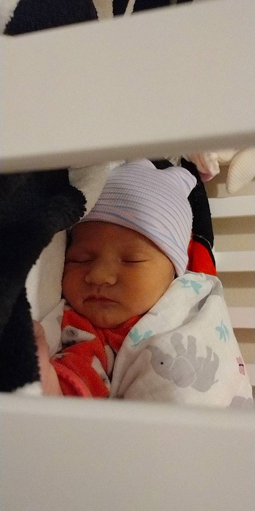 Judith is registered to the contest to win money with this photo: baby, baby_products, baby_sleeping, baby_toddler_clothing, beanie, bedding, bedtime, cap, cheek, child, comfort, happy, headgear, headwear, knit_cap, linens, outerwear, person, room, sleeve