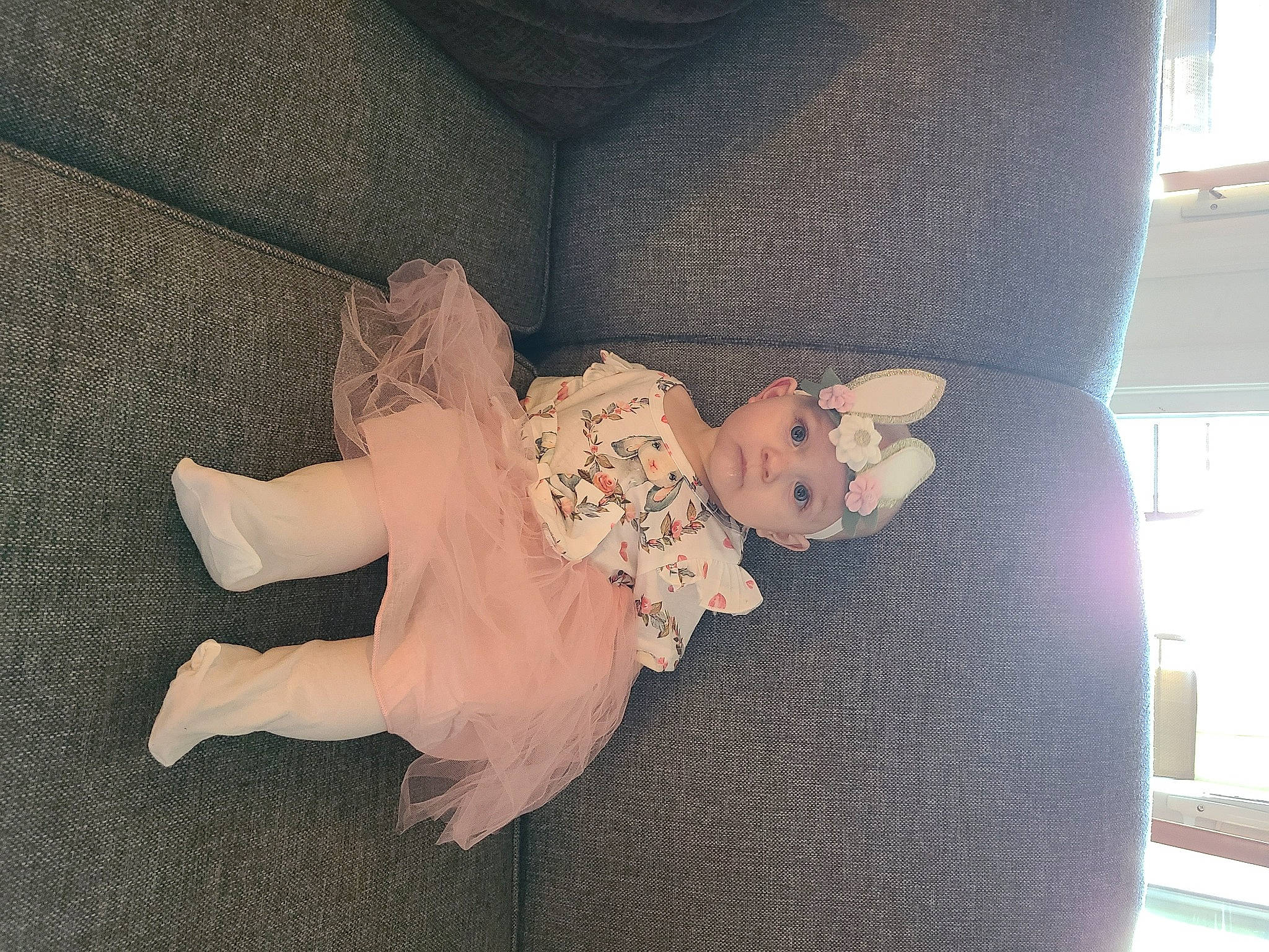 Rylee is registered to the contest to win money with this photo: baby_toddler_clothing, comfort, couch, dress, embellishment, flooring, foot, hand, headwear, human_body, human_leg, leg, linens, nail, pattern, person, ruffle, sleeve, thigh, waist