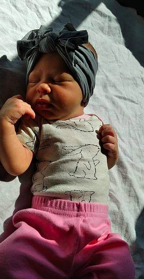 Emberlee is registered to the contest to win money with this photo: baby, baby_toddler_clothing, cap, cheek, comfort, finger, gesture, hand, happy, head, headgear, human, human_body, lip, mouth, person, pink, skin, sleeve, textile