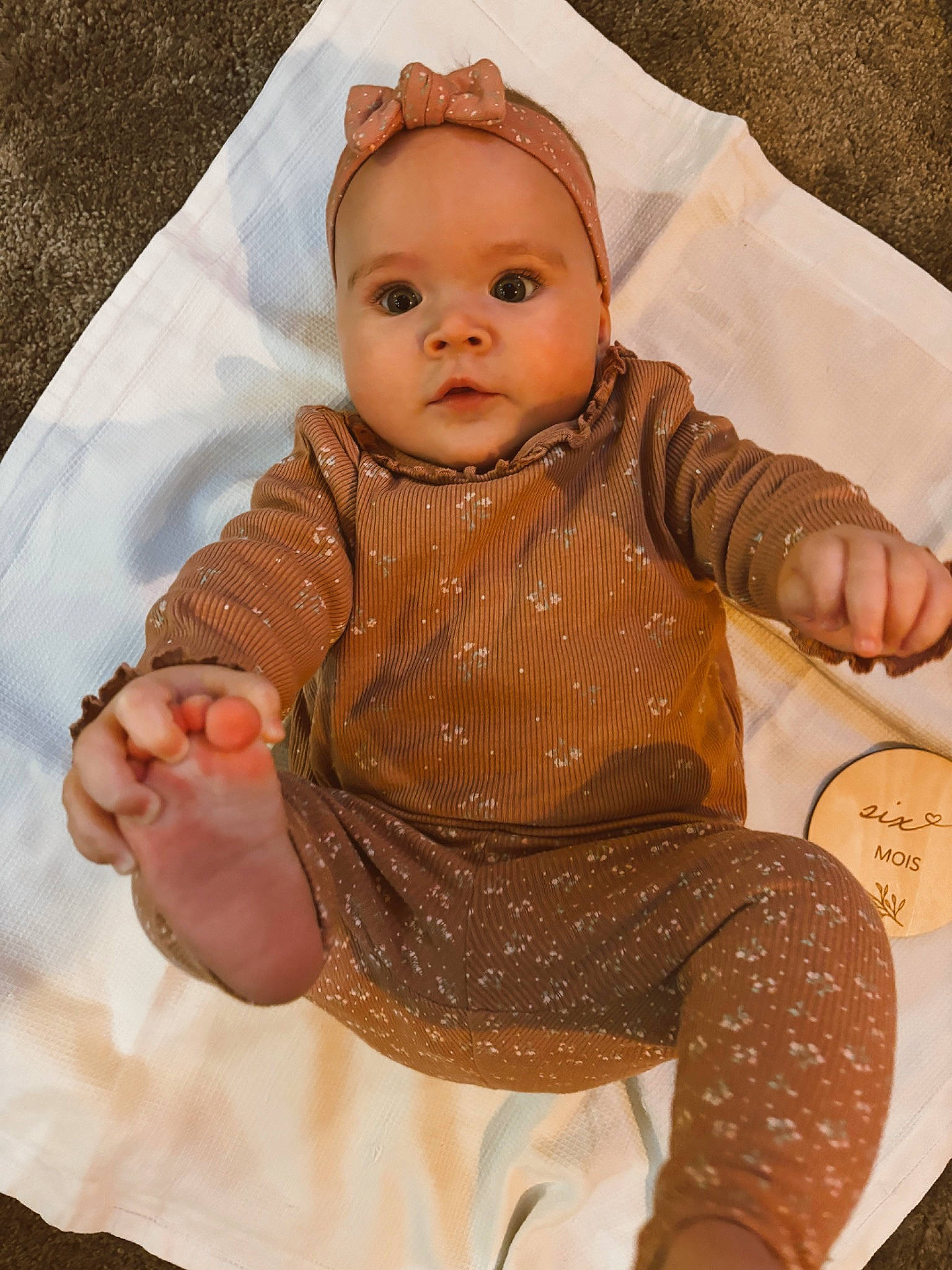 Maddo participe au concours pour gagner de l'argent avec cette photo : baby, baby_toddler_clothing, baby_toys, cheek, child, doll, eye, head, headwear, nose, outerwear, pattern, peach, person, sitting, skin, sleeve, textile, thumb, toy