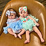 Abagail is registered to the contest to win money with this photo: baby, babies, chair, leather, dress, headband, infant, cute, smile, curious, legs, feet, sitting, indoor, wood_floor, colorful_clothing, tutu, person, friendship, adorable