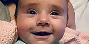 Abagail joined the competition — help win amazing prizes! baby, smiling, close_up, face, infant, blue_outfit, blanket, hand, skin, eyes, happy, child, soft, indoor, portrait, cute, newborn, person, head, cozy