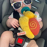 Delilah joined the competition — help win amazing prizes! baby, car_seat, sunglasses, headband, pacifier, plush_toy, child, infant, seatbelt, reflection, person, hand, foot, clothing, toy, cute, indoor, seat, pink, yellow