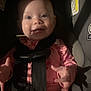 baby, car_seat, child, smiling, pink_clothing, seatbelt, plush_toy, indoor, face, hands, infant, child_safety, cute, baby_girl, sitting, toy, closeup, seat, straps, happy