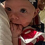 Delilah is registered to the contest to win money with this photo: adult, baby, blue, closeup, clothing, costume, eye, face, fingers, hand, headband, infant, paint, person, portrait, red, skin, stars, stripes, white