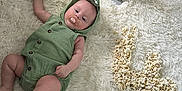 Lylia a rejoint le concours — aidez-le/la à gagner de superbes lots ! baby, birthday, celebration, child, cute, dinosaur_onesie, fluffy_rug, fun, green_clothing, home, indoor, infant, ipad, lying_down, netflix, number_four, pacifier, popcorn, relaxing, soft_texture