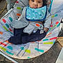 Isley is registered to the contest to win money with this photo: baby, infant, child, face, bib, baby_rocker, seat_belt, curly_hair, outdoor, pavement, colorful, clothing, blue, navy_pants, expression, pout, seat, toy_monkey, sunlight, comfort